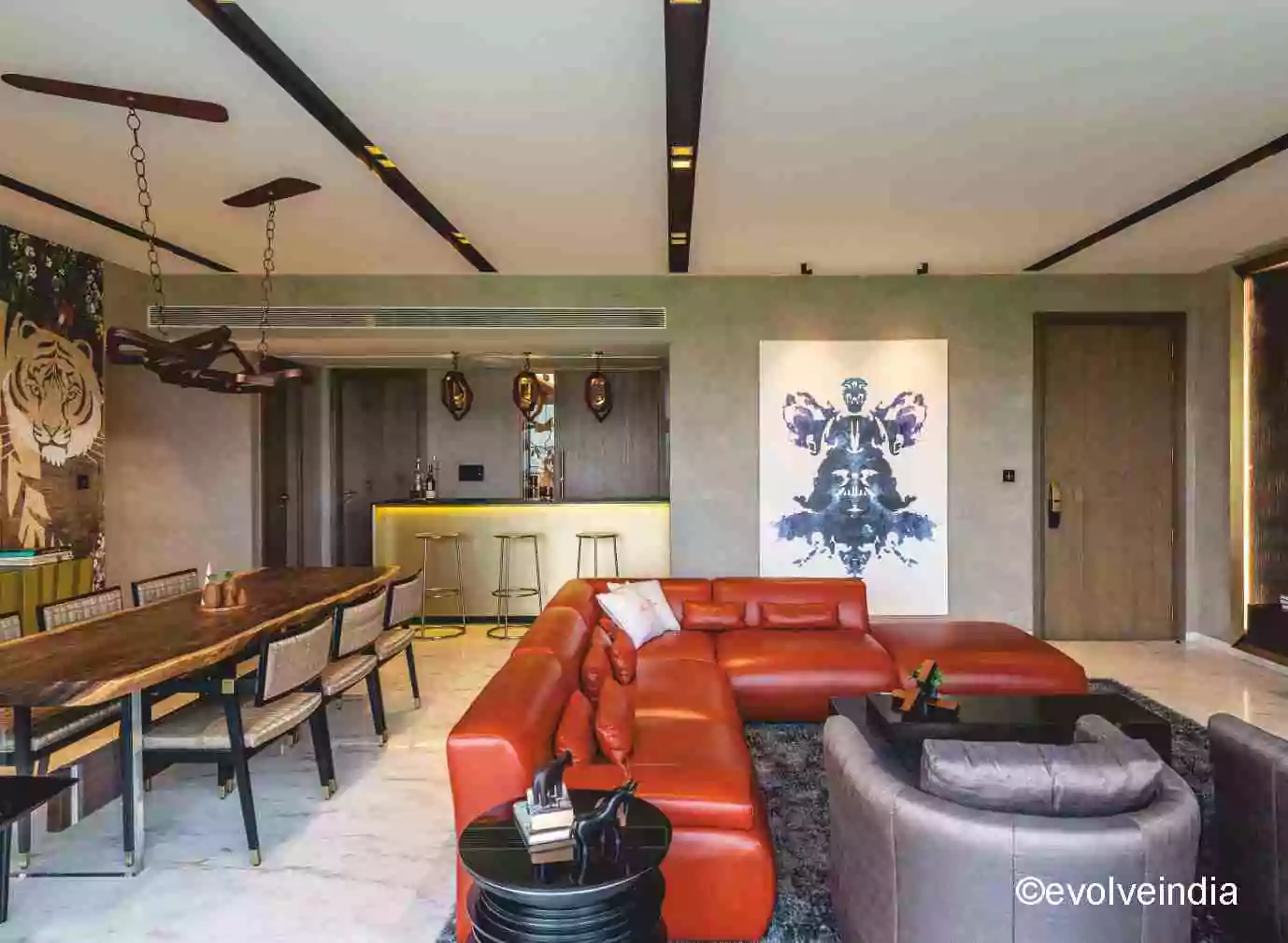 Seamless wall designed using textured concrete and liquid metal finishes by Evolve India